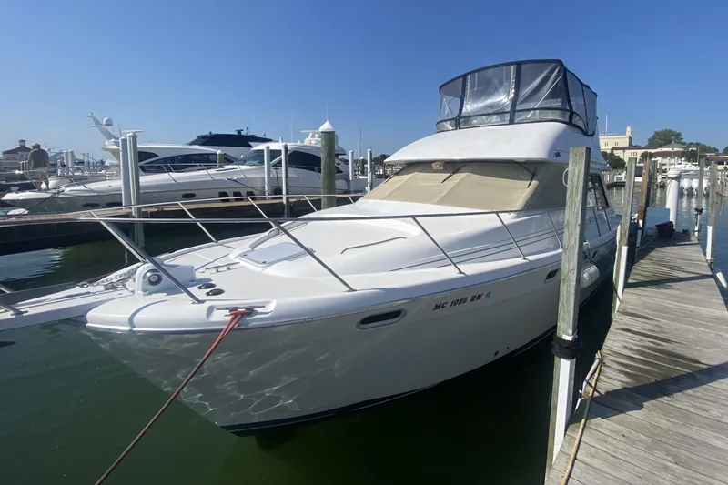The Image of 1997 Bayliner 3988 Motoryacht docked at marina under clear blue sky. - 0