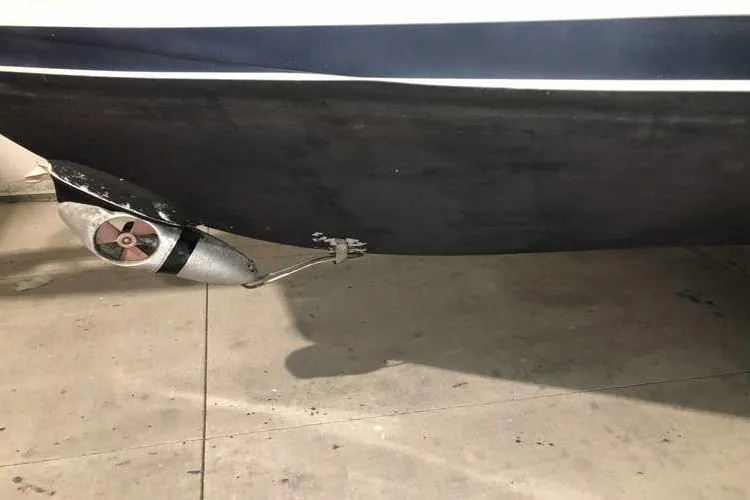 Slide: The Image of 1997 Bayliner 3988 Motoryacht hull and propeller detail in a garage setting. - 11