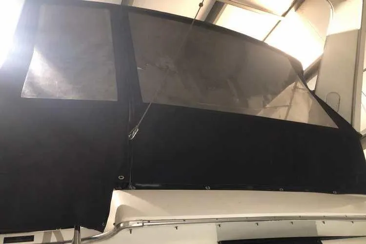 Slide: The Image of 1997 Bayliner 3988 Motoryacht with covered upper deck in storage facility. - 14