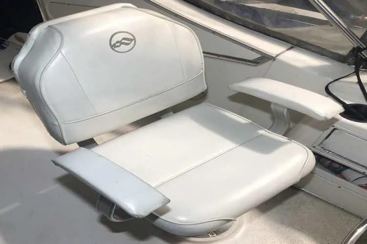 Slide: The Image of White captain's chair on 1997 Bayliner 3988 Motoryacht, featuring armrests and logo. - 21