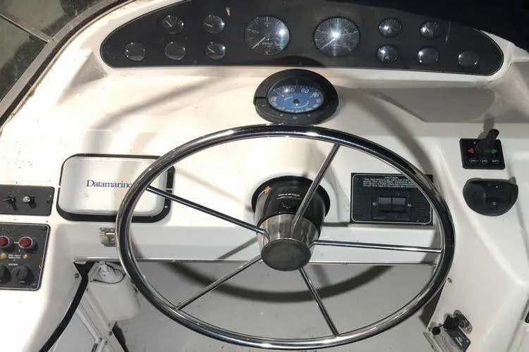 Slide: The Image of 1997 Bayliner 3988 Motoryacht helm with steering wheel and instrument panel. - 22