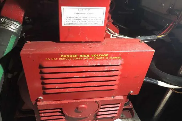 Slide: The Image of 1997 Bayliner 3988 Motoryacht generator with high voltage warning label. - 27