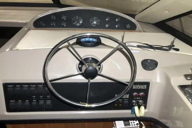 Slide: The Image of 1997 Bayliner 3988 Motoryacht helm with steering wheel and instrument panel. - 31