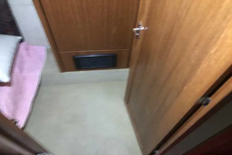 Slide: The Image of 1997 Bayliner 3988 Motoryacht interior with wooden door and cozy sleeping area. - 43