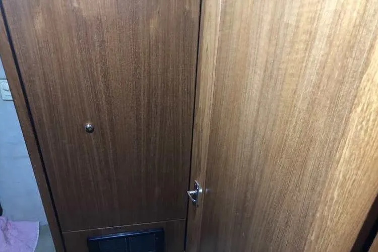 Slide: The Image of Interior wooden door of 1997 Bayliner 3988 Motoryacht, showcasing cabin craftsmanship. - 44