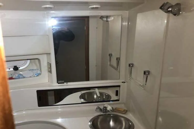 Slide: The Image of 1997 Bayliner 3988 Motoryacht bathroom with mirror, sink, and storage. - 48