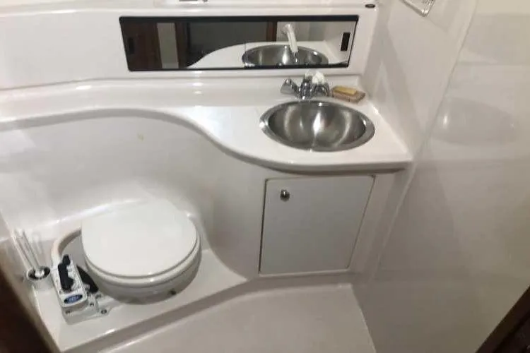 Slide: The Image of 1997 Bayliner 3988 Motoryacht bathroom with sink, toilet, and mirror. - 49