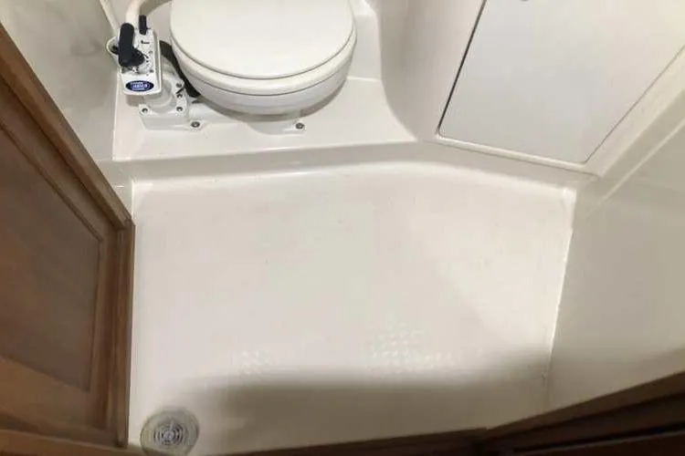 Slide: The Image of 1997 Bayliner 3988 Motoryacht bathroom with toilet and shower area. - 50