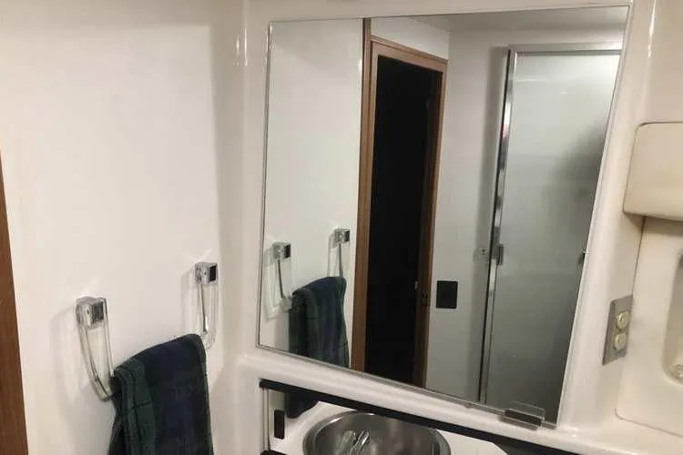 Slide: The Image of Bathroom interior of 1997 Bayliner 3988 Motoryacht with mirror and sink. - 54