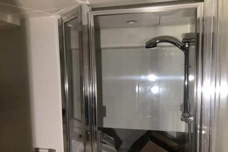 Slide: The Image of Shower area in 1997 Bayliner 3988 Motoryacht with glass enclosure and chrome fixtures. - 57