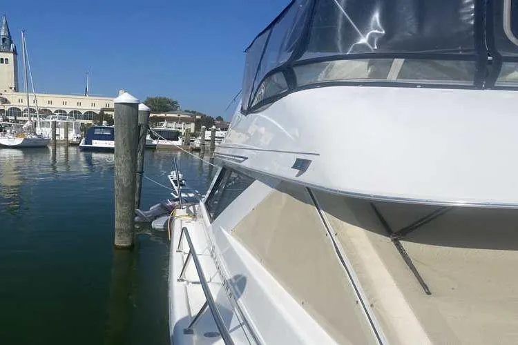 Slide: The Image of 1997 Bayliner 3988 Motoryacht docked at marina, clear blue sky, calm water. - 6