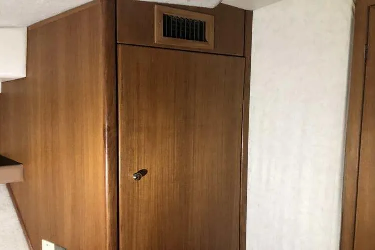 Slide: The Image of 1997 Bayliner 3988 Motoryacht interior with wooden cabinet and vent. - 65