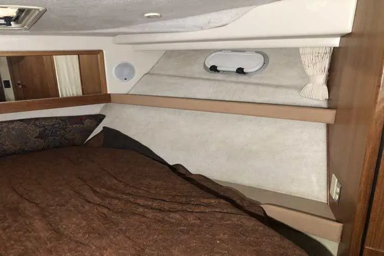 Slide: The Image of 1997 Bayliner 3988 Motoryacht interior cabin with bed and porthole window. - 68