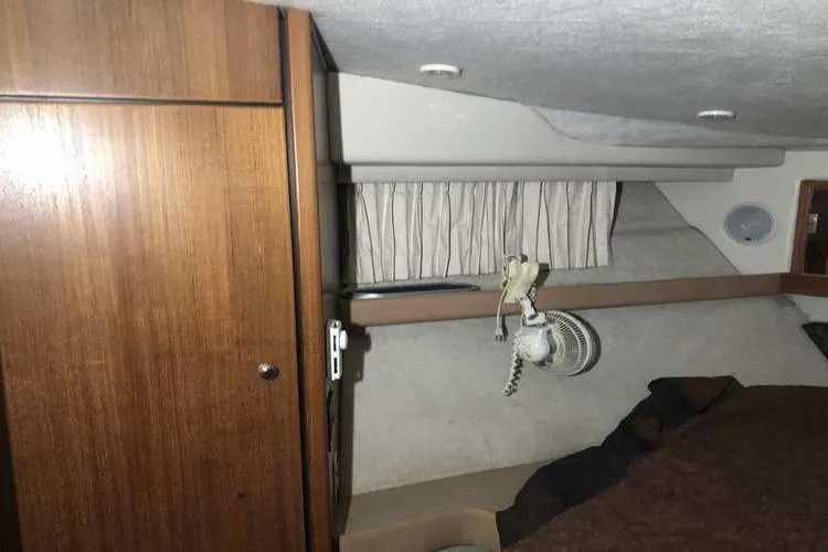 Slide: The Image of Interior cabin of 1997 Bayliner 3988 Motoryacht with wood paneling and cozy bedding. - 70