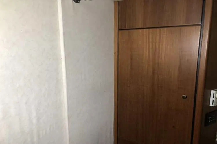 Slide: The Image of Interior view of 1997 Bayliner 3988 Motoryacht with wooden door and white wall. - 71