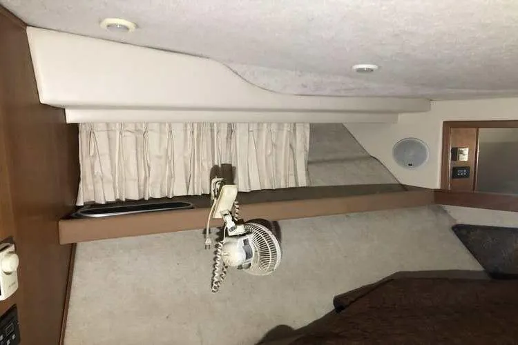 Slide: The Image of Interior cabin of 1997 Bayliner 3988 Motoryacht with fan and curtains. - 74