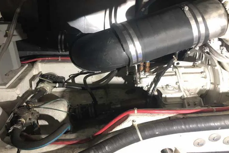 Slide: The Image of Engine compartment of 1997 Bayliner 3988 Motoryacht, showing hoses and mechanical components. - 77