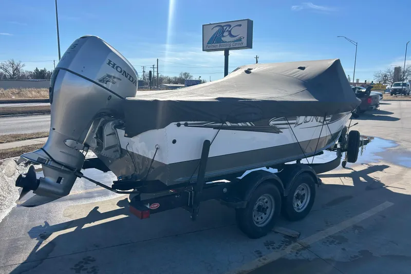 Slide: The Image of 2013 Lund 1800 Sport Angler boat with Honda outboard motor, covered and on trailer. - 11