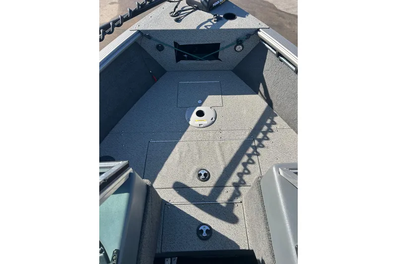 Slide: The Image of 2013 Lund 1800 Sport Angler boat interior with storage compartments and fishing rod holders. - 12