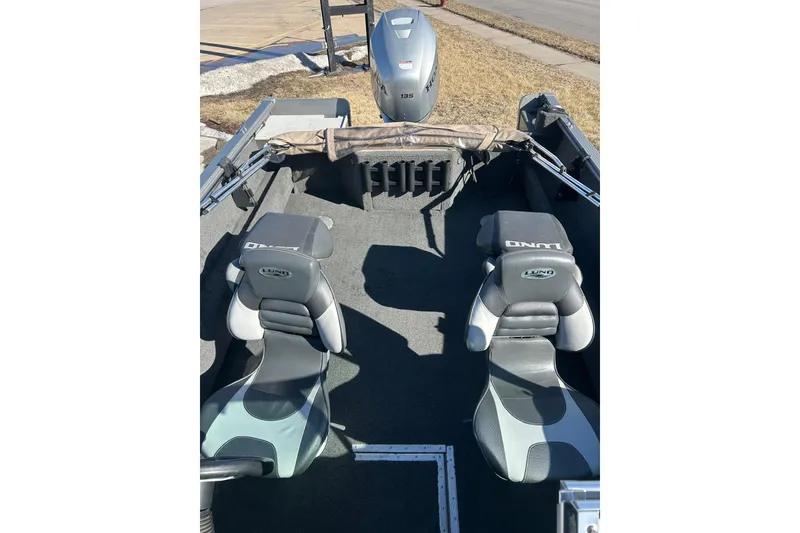 Slide: The Image of 2013 Lund 1800 Sport Angler boat interior with two seats and motor. - 16