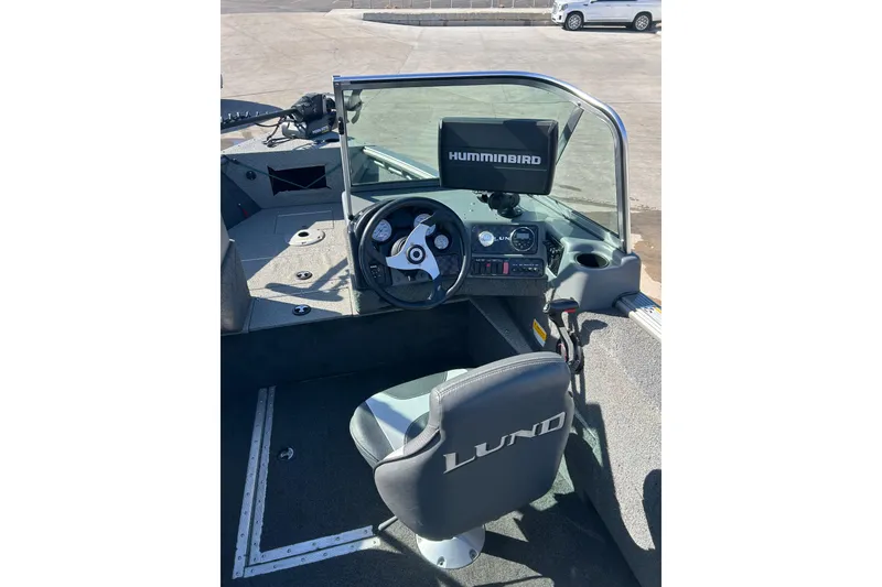 Slide: The Image of 2013 Lund 1800 Sport Angler boat interior with steering wheel and Humminbird display. - 18