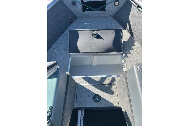 Slide: The Image of 2013 Lund 1800 Sport Angler boat interior with open storage compartment. - 20