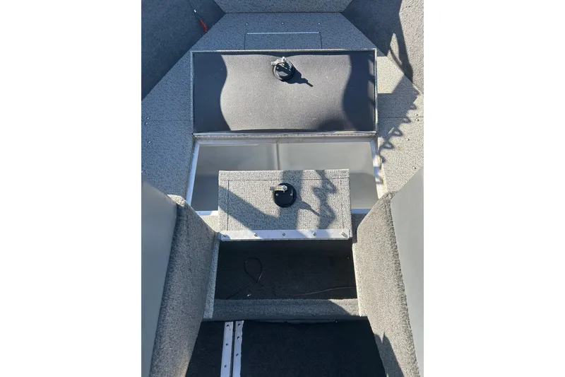 Slide: The Image of 2013 Lund 1800 Sport Angler interior with storage compartments and carpeted flooring. - 22