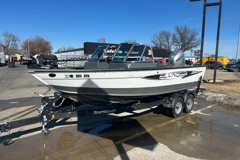 Slide: The Image of 2013 Lund 1800 Sport Angler boat on trailer in parking lot. - 3