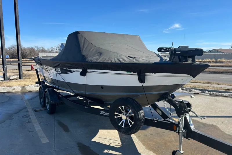 Slide: The Image of 2013 Lund 1800 Sport Angler boat on trailer, covered, parked outdoors. - 6