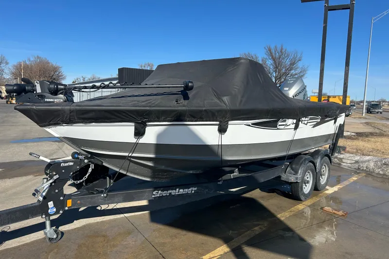 Slide: The Image of 2013 Lund 1800 Sport Angler boat on trailer with cover, parked outdoors. - 7