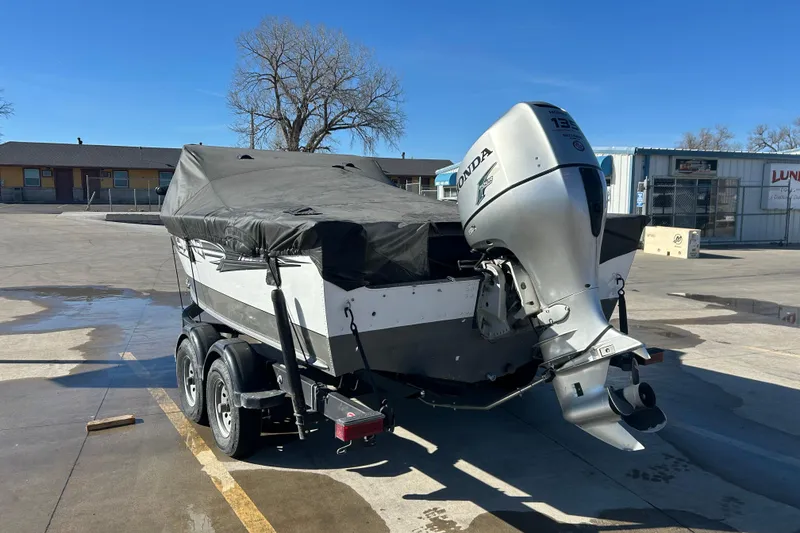Slide: The Image of 2013 Lund 1800 Sport Angler boat with Honda outboard motor, covered and on trailer. - 9