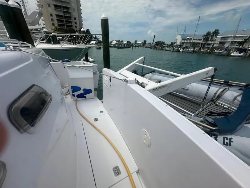 Slide: The Image of 1999 Mainship 430 Trawler docked at marina with inflatable boat. - 13