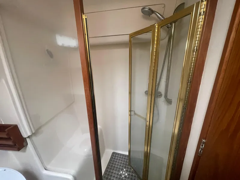 Slide: The Image of Shower area in 1999 Mainship 430 Trawler with glass door and chrome fixtures. - 37