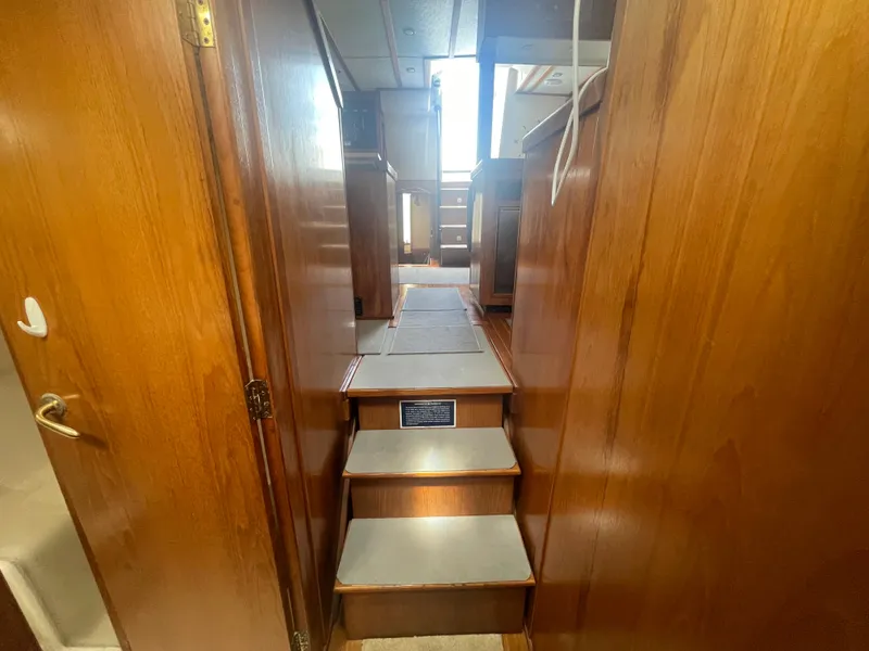 Slide: The Image of Interior view of 1999 Mainship 430 Trawler, featuring wooden stairs and hallway. - 39