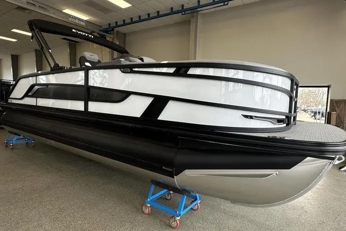 Slide: The Image of 2026 Evotti 723QL pontoon boat in showroom, featuring sleek black and white design. - 10