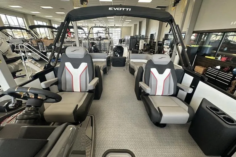 Slide: The Image of 2026 Evotti 723QL boat interior with modern seating and sleek design in showroom. - 20