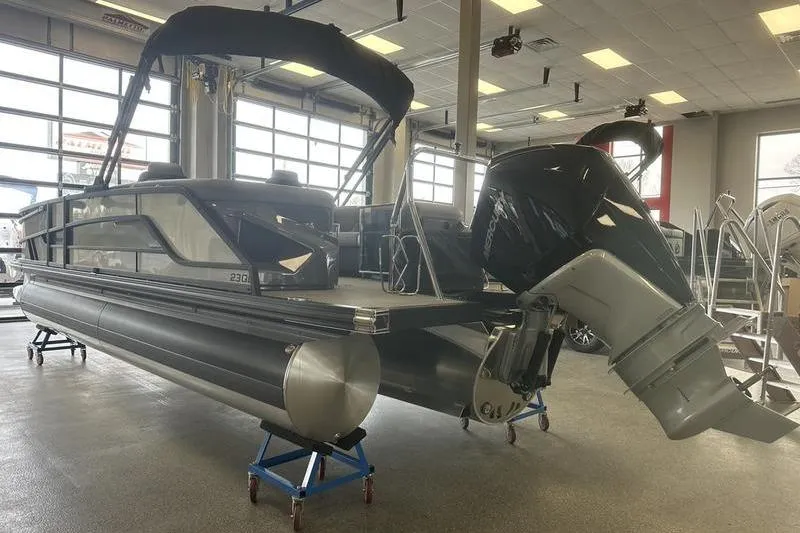 Slide: The Image of 2026 Evotti 723QL pontoon boat in a garage, showcasing rear view and motor. - 4