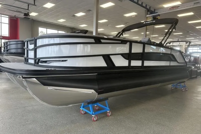 Slide: The Image of 2026 Evotti 723QL pontoon boat in showroom, featuring sleek design and powerful outboard motor. - 5