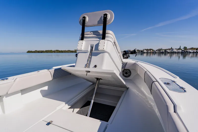 Slide: The Image of 2024 Dorado 25 boat interior with open storage, calm water, and clear sky. - 25