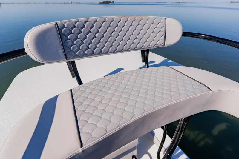 Slide: The Image of 2024 Dorado 25 boat with elegant quilted seating, overlooking calm waters. - 34