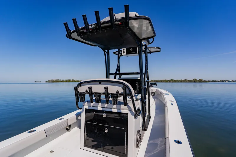 Slide: The Image of 2024 Dorado 25 boat on calm water, featuring sleek design and fishing rod holders. - 35