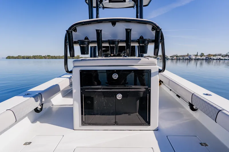 Slide: The Image of 2024 Dorado 25 boat interior with storage compartment, calm water, and clear sky. - 36