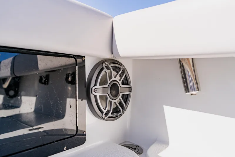 Slide: The Image of 2024 Dorado 25 boat interior with speaker and stainless steel rod holder. - 43