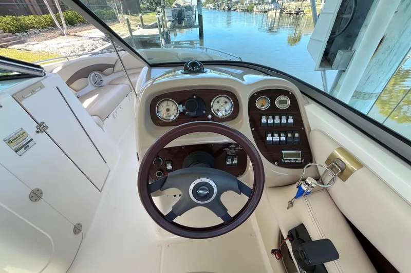 Slide: The Image of 2006 Chaparral 246 SSi boat dashboard with steering wheel and control panel. - 13