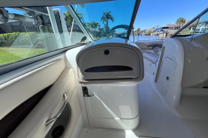 Slide: The Image of Interior view of 2006 Chaparral 246 SSi boat, featuring sleek design and waterfront scenery. - 14