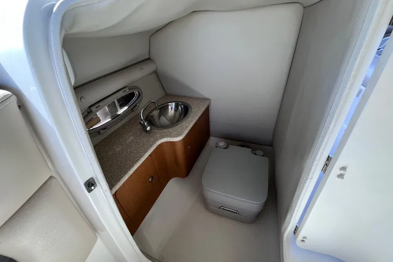 Slide: The Image of Compact bathroom in 2006 Chaparral 246 SSi boat with sink and portable toilet. - 15