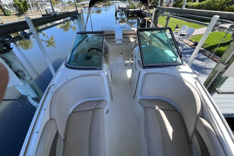 Slide: The Image of 2006 Chaparral 246 SSi boat docked, featuring spacious seating and sleek design. - 18