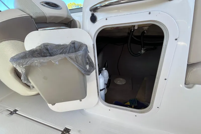 Slide: The Image of 2006 Chaparral 246 SSi boat interior with storage compartment and trash bin. - 25