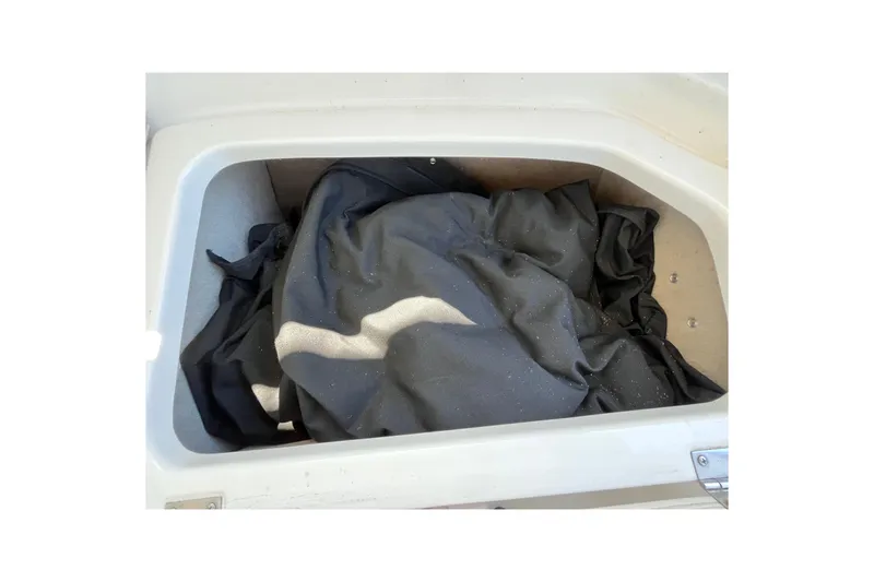 Slide: The Image of Storage compartment in a 2006 Chaparral 246 SSi boat with black fabric inside. - 40