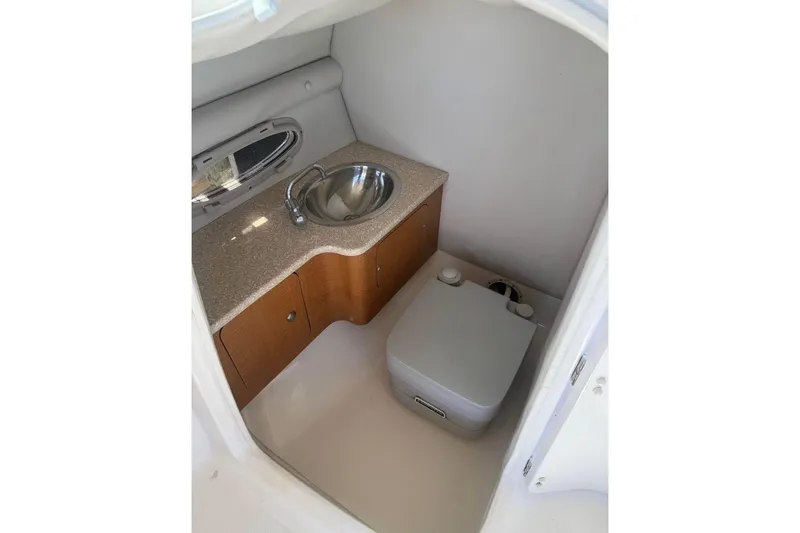 Slide: The Image of 2006 Chaparral 246 SSi boat interior with sink and compact toilet. - 9